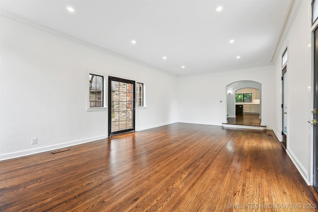 2605 S St Louis Ave, Tulsa, OK 74114 - empty room with arched walkways, crown molding, dark wood finished floors, and recessed lighting