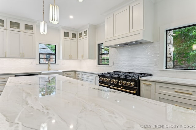 2605 S St Louis Ave, Tulsa, OK 74114 - kitchen with high end stove, white cabinets, tasteful backsplash, glass insert cabinets, and recessed lighting