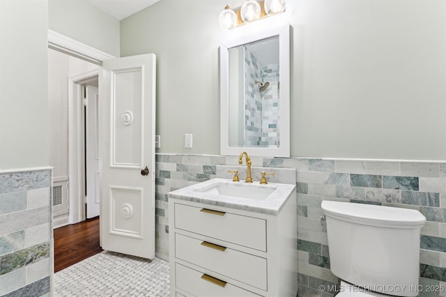 2605 S St Louis Ave, Tulsa, OK 74114 - bathroom with tile walls, vanity, and wainscoting