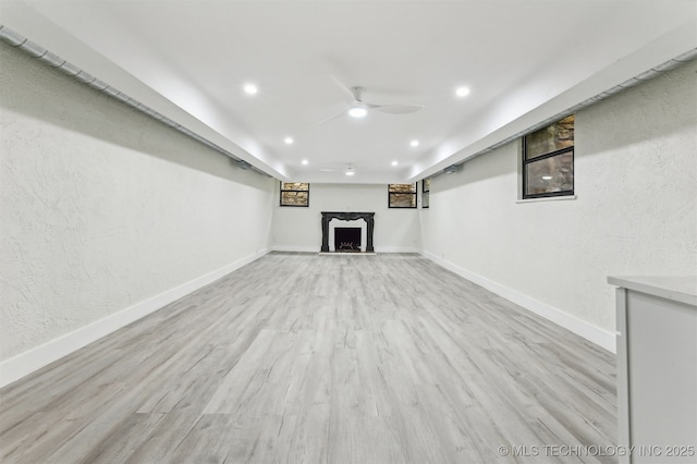 2605 S St Louis Ave, Tulsa, OK 74114 - finished below grade area with a ceiling fan, a fireplace, recessed lighting, light wood finished floors, and a textured wall