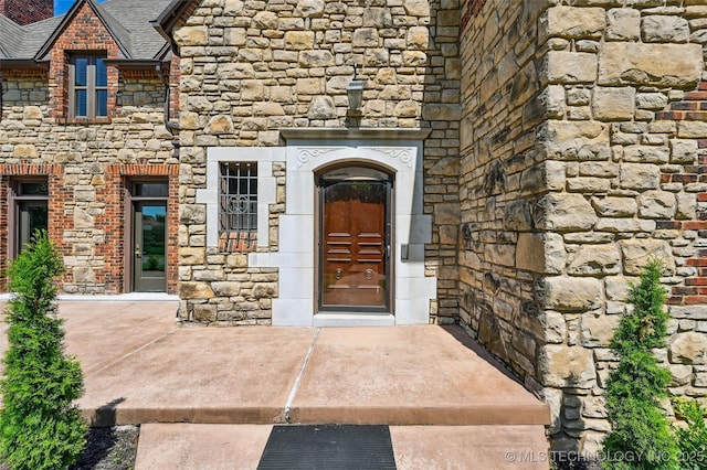 2605 S St Louis Ave, Tulsa, OK 74114 - entrance to property featuring stone siding and a shingled roof