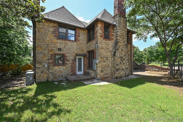 2605 S St Louis Ave, Tulsa, OK 74114 - back of house with stone siding and a chimney