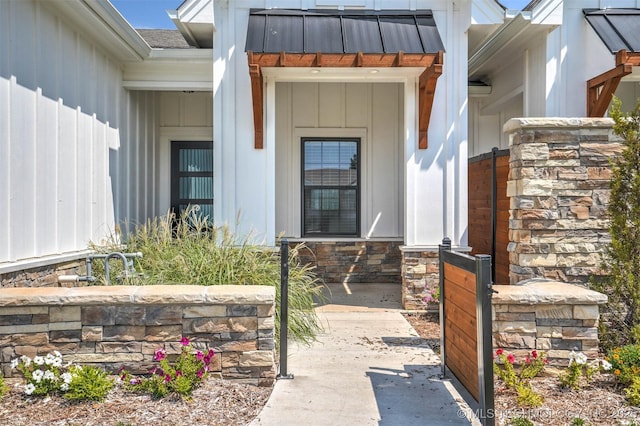1914 W Imperial St, Broken Arrow, OK 74011 - entrance to property with board and batten siding, a standing seam roof, stone siding, and a metal roof