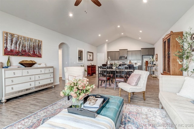 1914 W Imperial St, Broken Arrow, OK 74011 - living area with arched walkways, light wood finished floors, ceiling fan, recessed lighting, and high vaulted ceiling