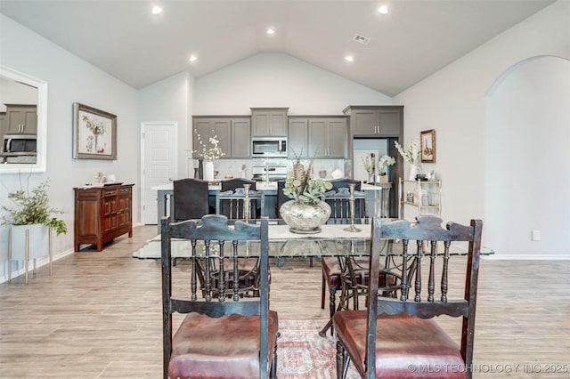 1914 W Imperial St, Broken Arrow, OK 74011 - dining room featuring arched walkways, light wood-style floors, recessed lighting, and high vaulted ceiling