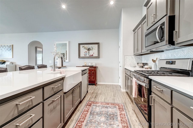1914 W Imperial St, Broken Arrow, OK 74011 - kitchen with stainless steel appliances, light wood finished floors, light countertops, tasteful backsplash, and gray cabinetry