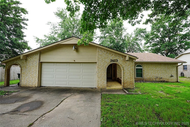 2613 Turner St, Muskogee, OK 74403 - ranch-style home with brick siding, an attached garage, concrete driveway, and a front yard