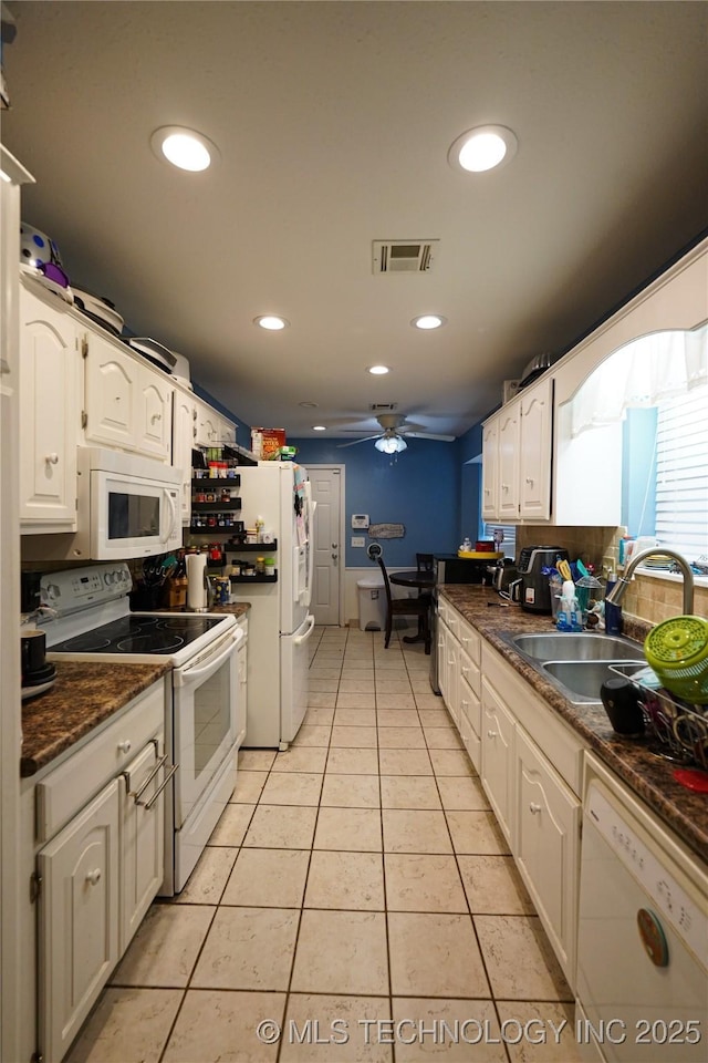 2613 Turner St, Muskogee, OK 74403 - kitchen with white appliances, dark countertops, ceiling fan, light tile patterned floors, and recessed lighting