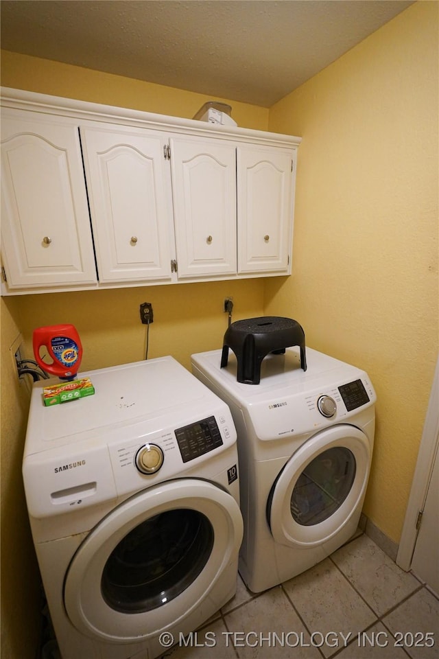2613 Turner St, Muskogee, OK 74403 - laundry room featuring washing machine and dryer, cabinet space, and light tile patterned floors