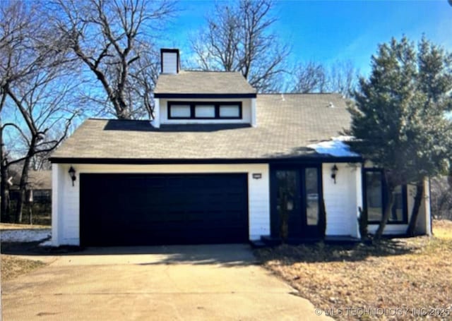 5117 S Lions Ave, Broken Arrow, OK 74011 - view of front of house featuring a chimney, driveway, and a garage