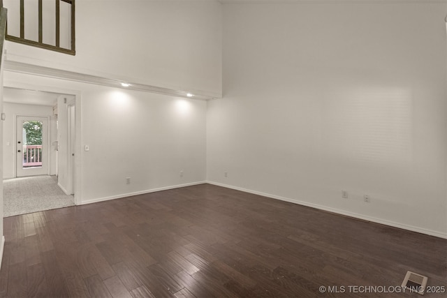 5117 S Lions Ave, Broken Arrow, OK 74011 - unfurnished room with dark wood-style floors and a towering ceiling