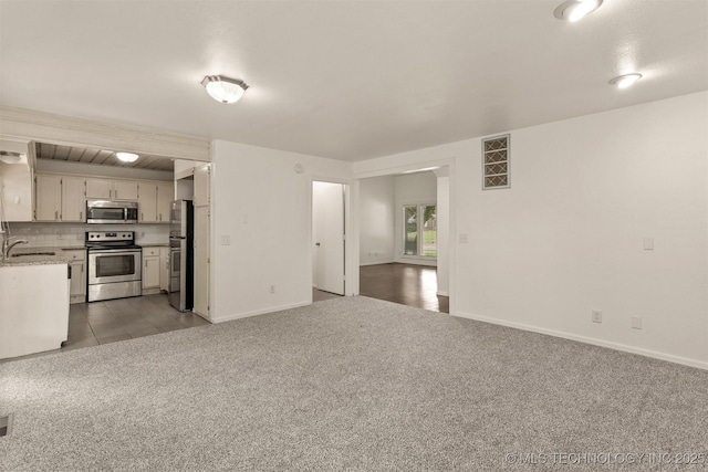 5117 S Lions Ave, Broken Arrow, OK 74011 - unfurnished living room with light carpet and a sink