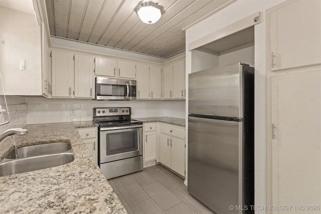 5117 S Lions Ave, Broken Arrow, OK 74011 - kitchen featuring appliances with stainless steel finishes, backsplash, wood ceiling, cream cabinets, and light stone counters
