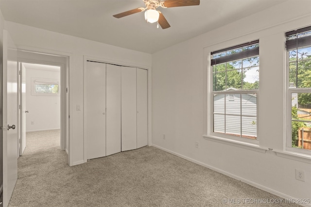 5117 S Lions Ave, Broken Arrow, OK 74011 - unfurnished bedroom with multiple windows, light carpet, and a closet