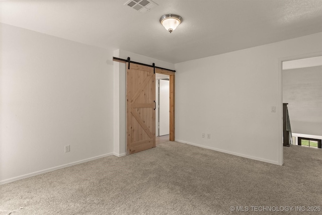 5117 S Lions Ave, Broken Arrow, OK 74011 - carpeted spare room featuring a barn door and baseboards