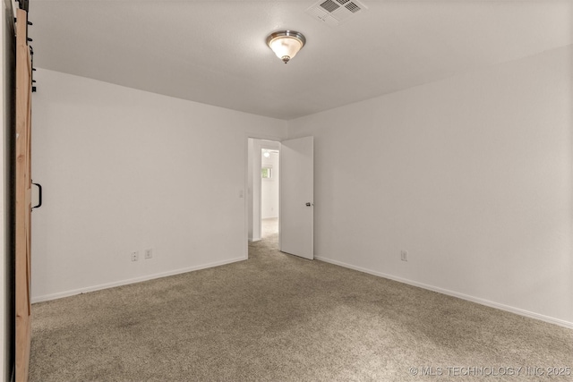 5117 S Lions Ave, Broken Arrow, OK 74011 - empty room with carpet flooring and a barn door