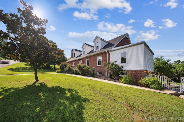 1210 E 15th St, Ada, OK 74820 - view of side of property featuring brick siding and a lawn