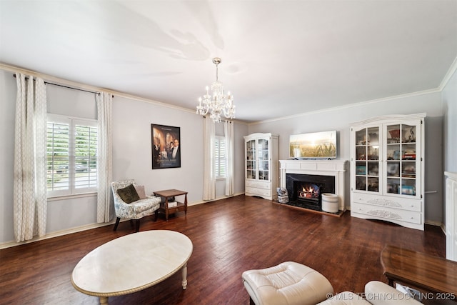 1210 E 15th St, Ada, OK 74820 - living area featuring a warm lit fireplace, a chandelier, ornamental molding, and wood finished floors