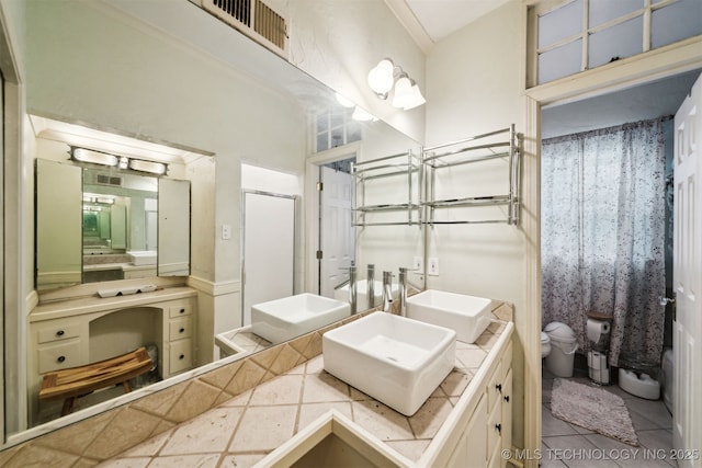 1210 E 15th St, Ada, OK 74820 - full bathroom with double vanity, a shower with door, and tile patterned floors