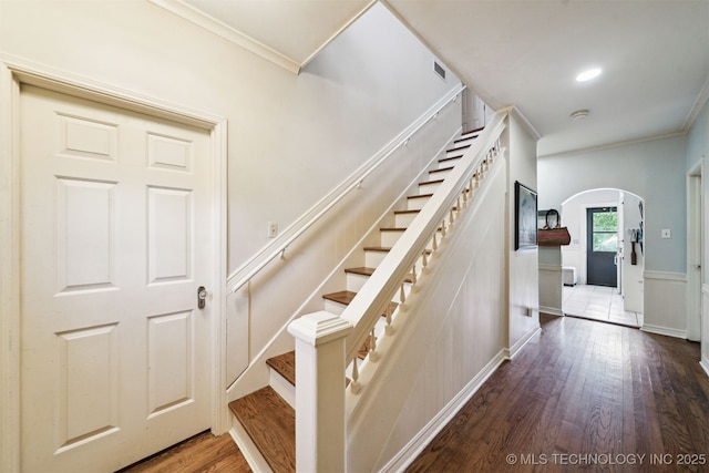 1210 E 15th St, Ada, OK 74820 - stairs featuring ornamental molding, arched walkways, wood finished floors, and a wainscoted wall