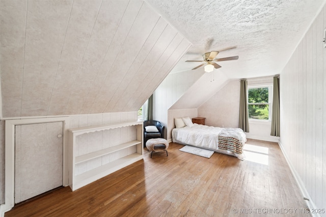 1210 E 15th St, Ada, OK 74820 - bedroom featuring wood-type flooring, vaulted ceiling, and a ceiling fan