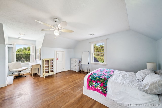 1210 E 15th St, Ada, OK 74820 - bedroom with lofted ceiling, wood finished floors, multiple windows, and a ceiling fan
