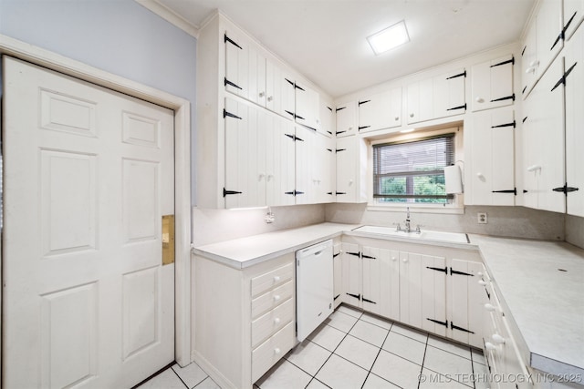 1210 E 15th St, Ada, OK 74820 - kitchen with dishwasher, light tile patterned flooring, light countertops, and white cabinets