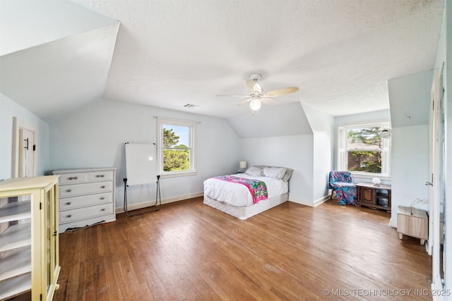 1210 E 15th St, Ada, OK 74820 - bedroom with vaulted ceiling, hardwood / wood-style floors, and a ceiling fan