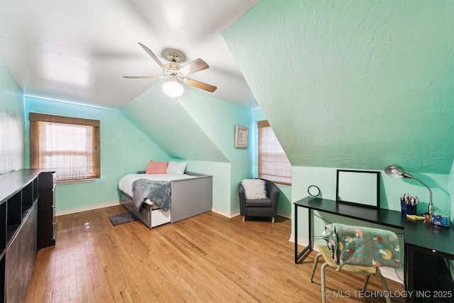 1210 E 15th St, Ada, OK 74820 - bedroom featuring wood finished floors, vaulted ceiling, and ceiling fan