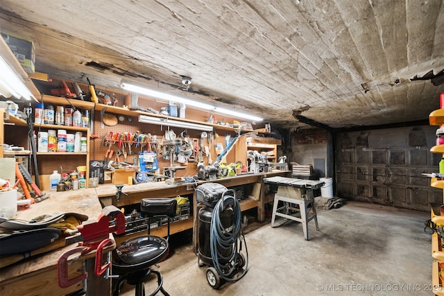1210 E 15th St, Ada, OK 74820 - miscellaneous room with unfinished concrete floors and a workshop area