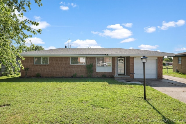 321 NE Elmhurst Ave, Bartlesville, OK 74006 - ranch-style home with driveway, a garage, a front lawn, and brick siding