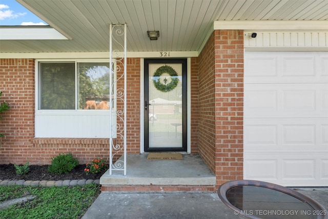 321 NE Elmhurst Ave, Bartlesville, OK 74006 - entrance to property featuring brick siding and an attached garage