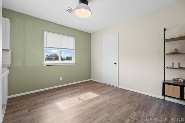 321 NE Elmhurst Ave, Bartlesville, OK 74006 - unfurnished bedroom featuring wood finished floors