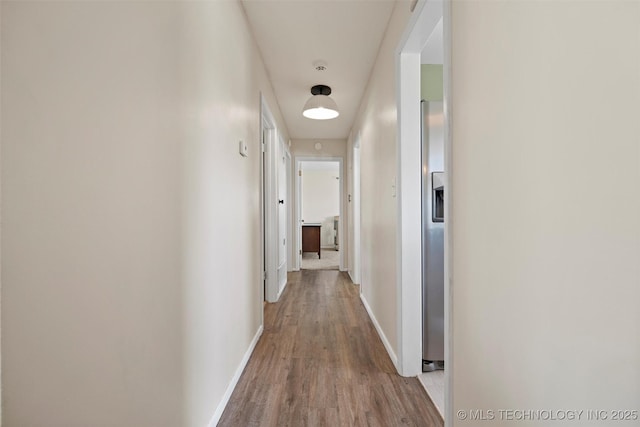321 NE Elmhurst Ave, Bartlesville, OK 74006 - hallway featuring wood finished floors and baseboards
