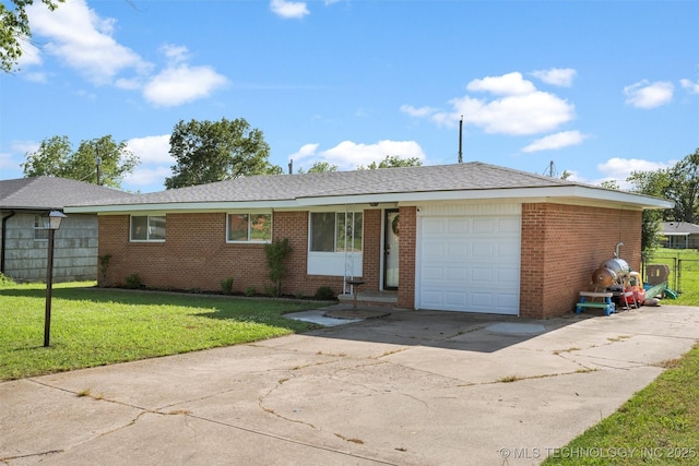 321 NE Elmhurst Ave, Bartlesville, OK 74006 - view of front of property with driveway, brick siding, and an attached garage
