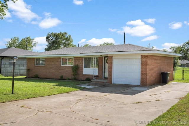 321 NE Elmhurst Ave, Bartlesville, OK 74006 - view of front of home featuring driveway, an attached garage, and brick siding