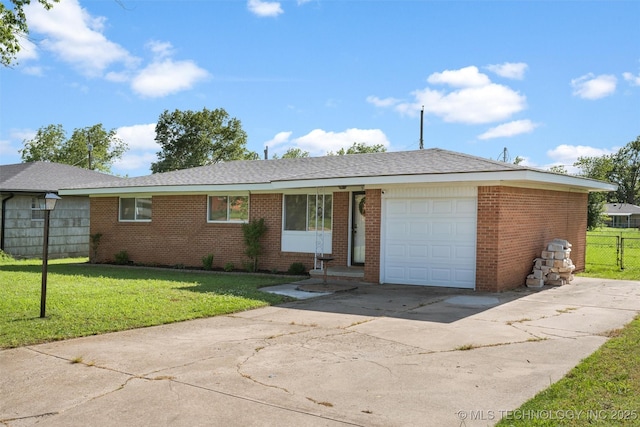 321 NE Elmhurst Ave, Bartlesville, OK 74006 - view of front of property with concrete driveway, an attached garage, and brick siding