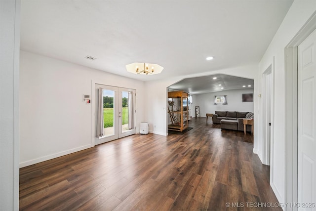 19471 E 335th Rd, Chelsea, OK 74016 - living room featuring dark wood-style flooring, french doors, arched walkways, recessed lighting, and a chandelier