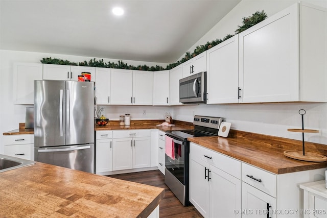 19471 E 335th Rd, Chelsea, OK 74016 - kitchen featuring appliances with stainless steel finishes, butcher block counters, dark wood-type flooring, and white cabinets