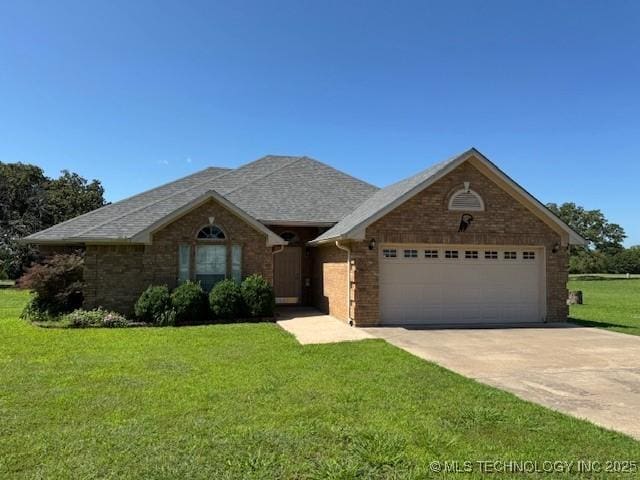 9 Arrowhead, Burneyville, OK 73430 - view of front facade with a garage, driveway, a front yard, and brick siding