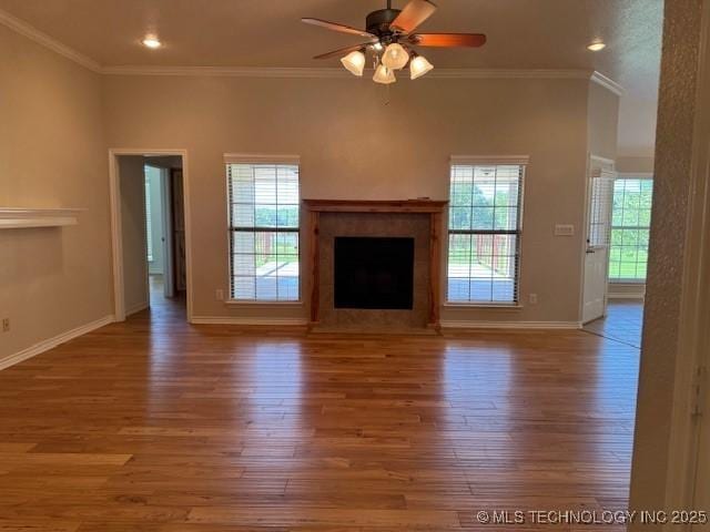 9 Arrowhead, Burneyville, OK 73430 - unfurnished living room with wood finished floors, plenty of natural light, crown molding, ceiling fan, and a fireplace