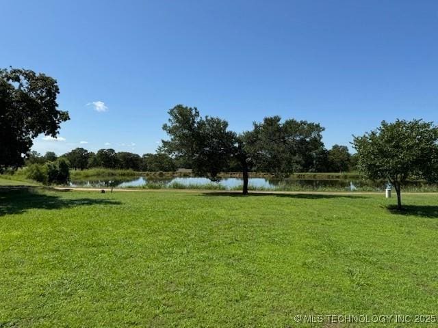 9 Arrowhead, Burneyville, OK 73430 - view of community with a water view and a lawn