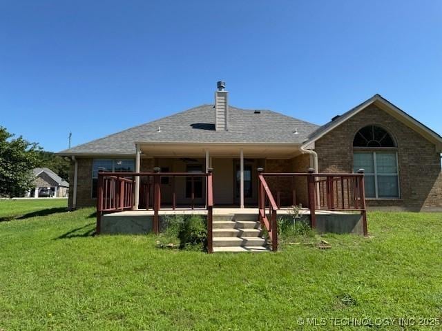 9 Arrowhead, Burneyville, OK 73430 - back of property with a lawn, a chimney, and brick siding