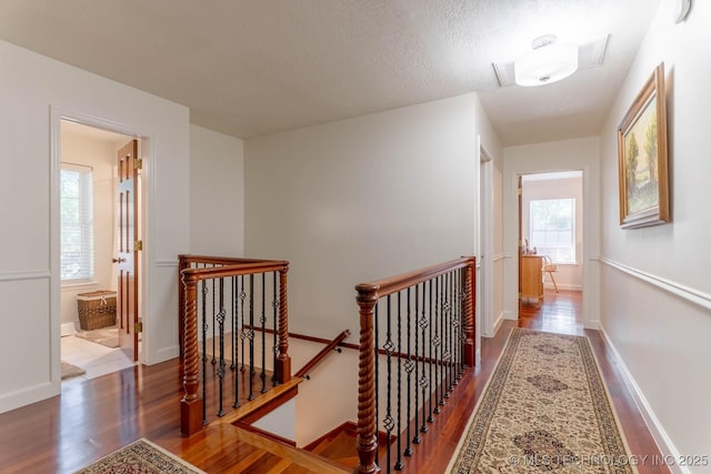 3107 E 84th St, Tulsa, OK 74137 - corridor featuring an upstairs landing, wood finished floors, and a textured ceiling