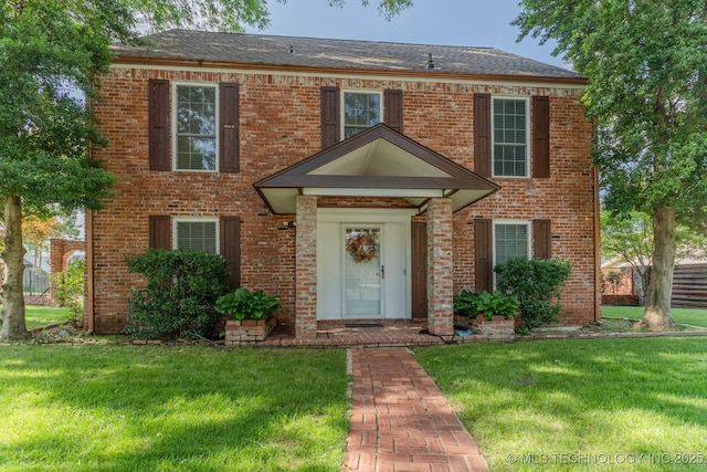 3107 E 84th St, Tulsa, OK 74137 - colonial house featuring a front yard and brick siding