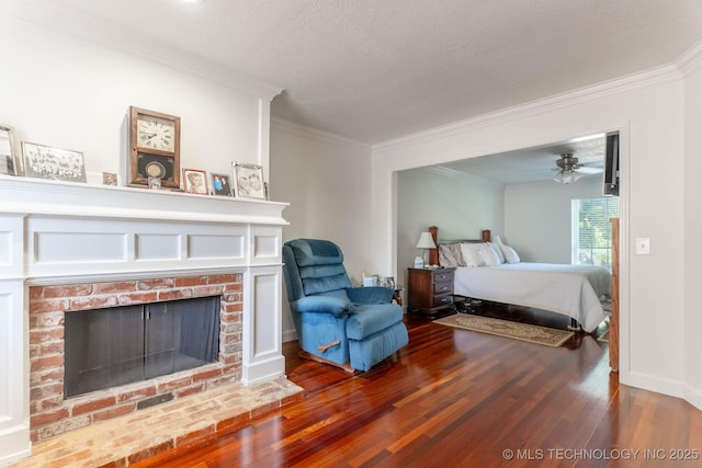 3107 E 84th St, Tulsa, OK 74137 - bedroom with crown molding, wood finished floors, a brick fireplace, and a textured ceiling