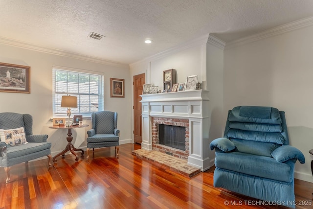 3107 E 84th St, Tulsa, OK 74137 - sitting room with wood finished floors, ornamental molding, a textured ceiling, and a brick fireplace