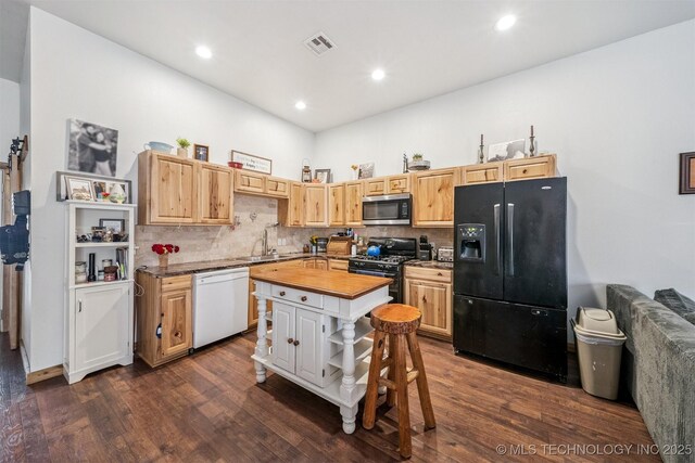 13560 S 4150th Rd, Claremore, OK 74017 - kitchen with black refrigerator with ice dispenser, white dishwasher, stainless steel microwave, gas range, and wood counters