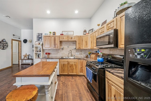 13560 S 4150th Rd, Claremore, OK 74017 - kitchen featuring fridge with ice dispenser, stainless steel microwave, black range with gas cooktop, dark wood finished floors, and recessed lighting