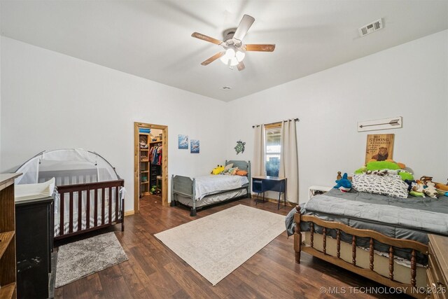 13560 S 4150th Rd, Claremore, OK 74017 - bedroom featuring wood finished floors, a walk in closet, ceiling fan, and a closet